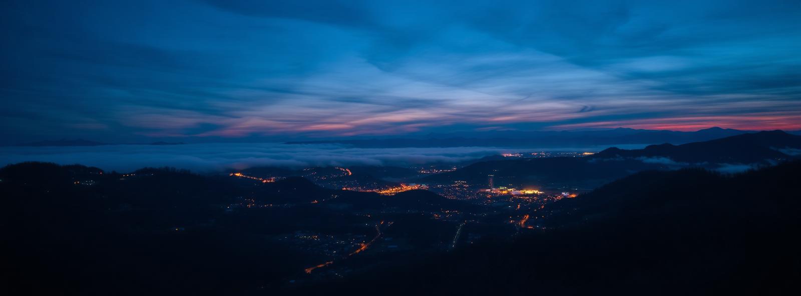 Aerial view of the Asheville, North Carolina skyline at dusk, illustrating the metro area TactStack serves trade and service businesses in