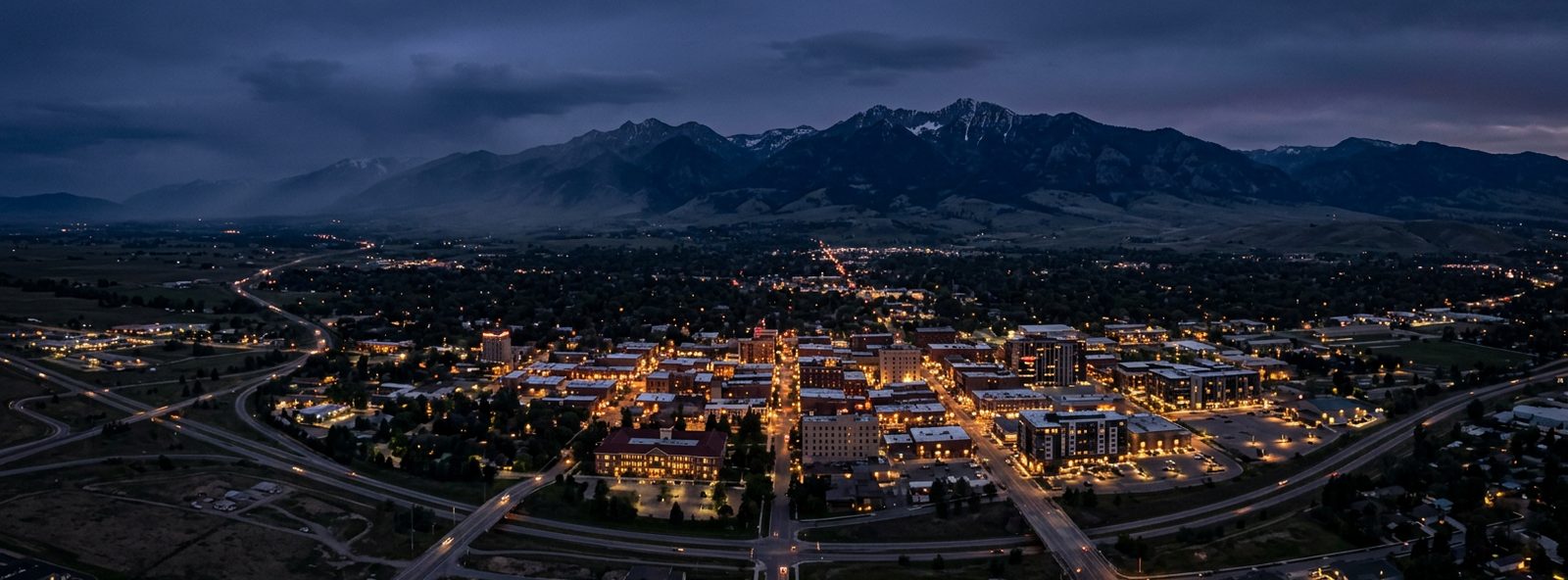 Aerial view of the Bozeman, Montana skyline at dusk, illustrating the metro area TactStack serves trade and service businesses in