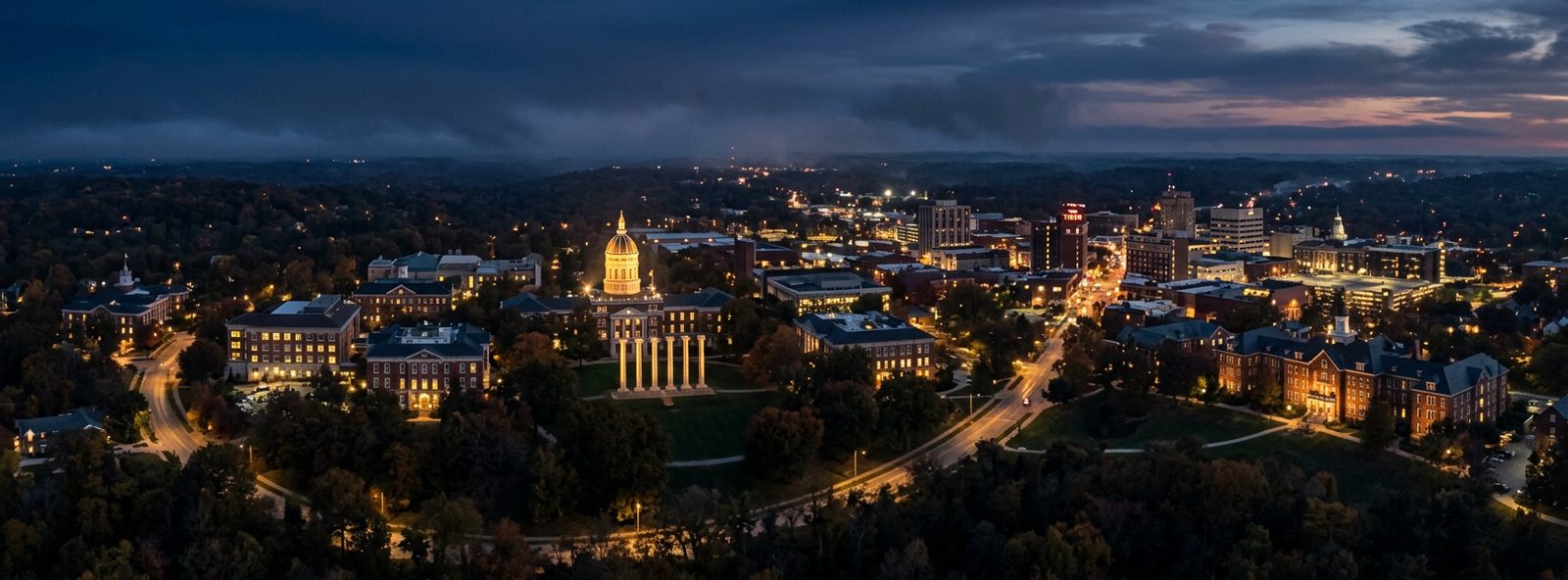 Aerial view of the Columbia, Missouri skyline at dusk, illustrating the metro area TactStack serves trade and service businesses in