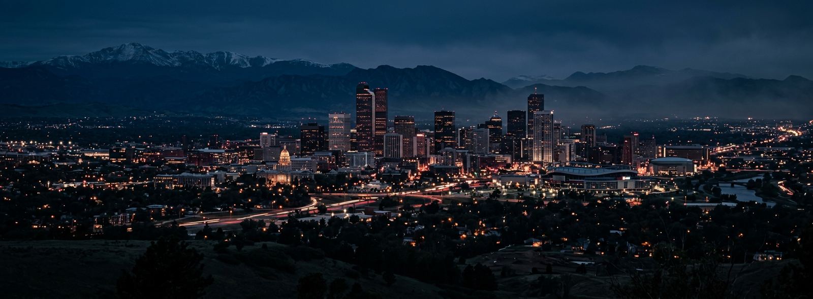 Aerial view of the Denver, Colorado skyline at dusk, illustrating the metro area TactStack serves trade and service businesses in
