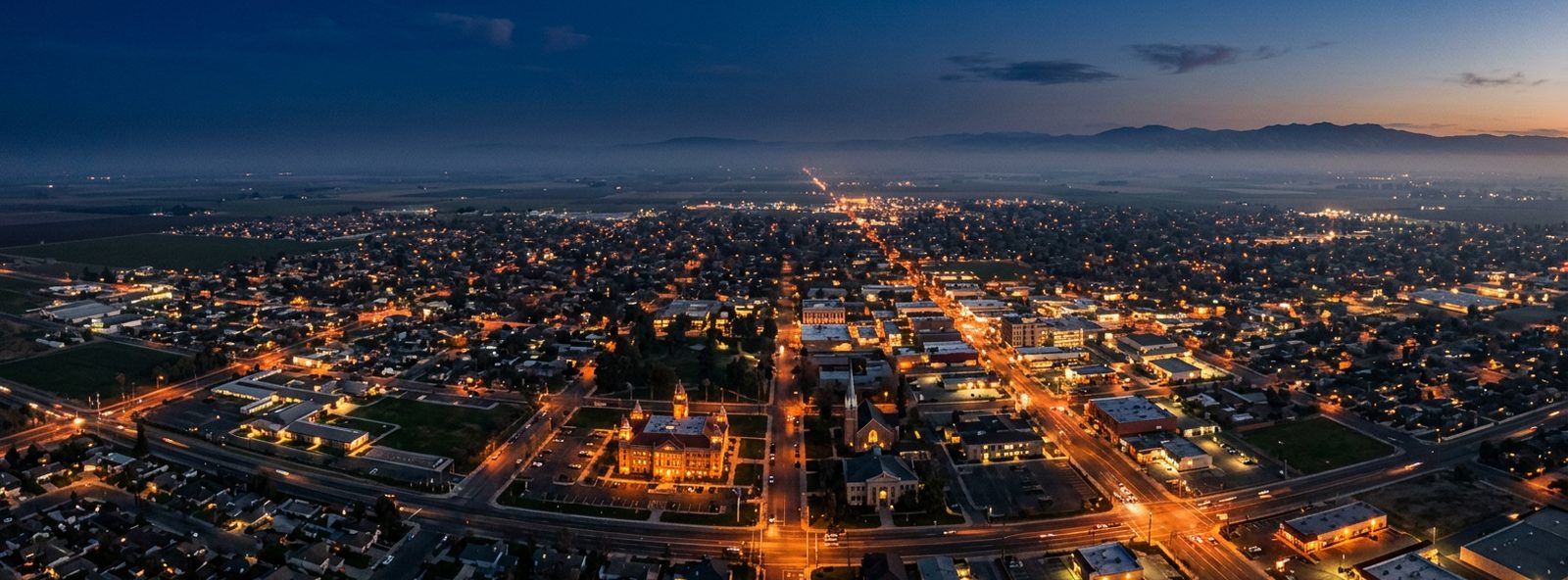 Aerial view of the Hanford, California skyline at dusk, illustrating the metro area TactStack serves trade and service businesses in