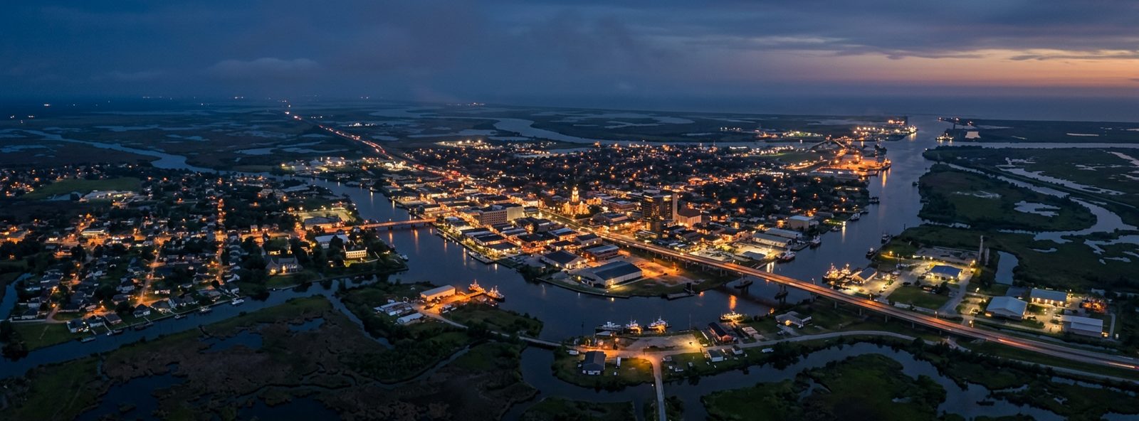 Aerial view of the Houma, Louisiana skyline at dusk, illustrating the metro area TactStack serves trade and service businesses in