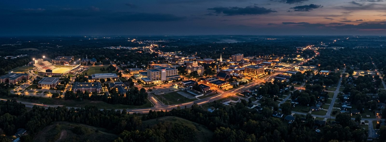 Aerial view of the Jonesboro, Arkansas skyline at dusk, illustrating the metro area TactStack serves trade and service businesses in
