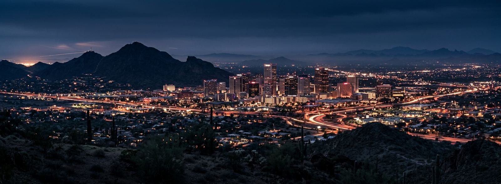 Aerial view of the Phoenix, Arizona skyline at dusk, illustrating the metro area TactStack serves trade and service businesses in