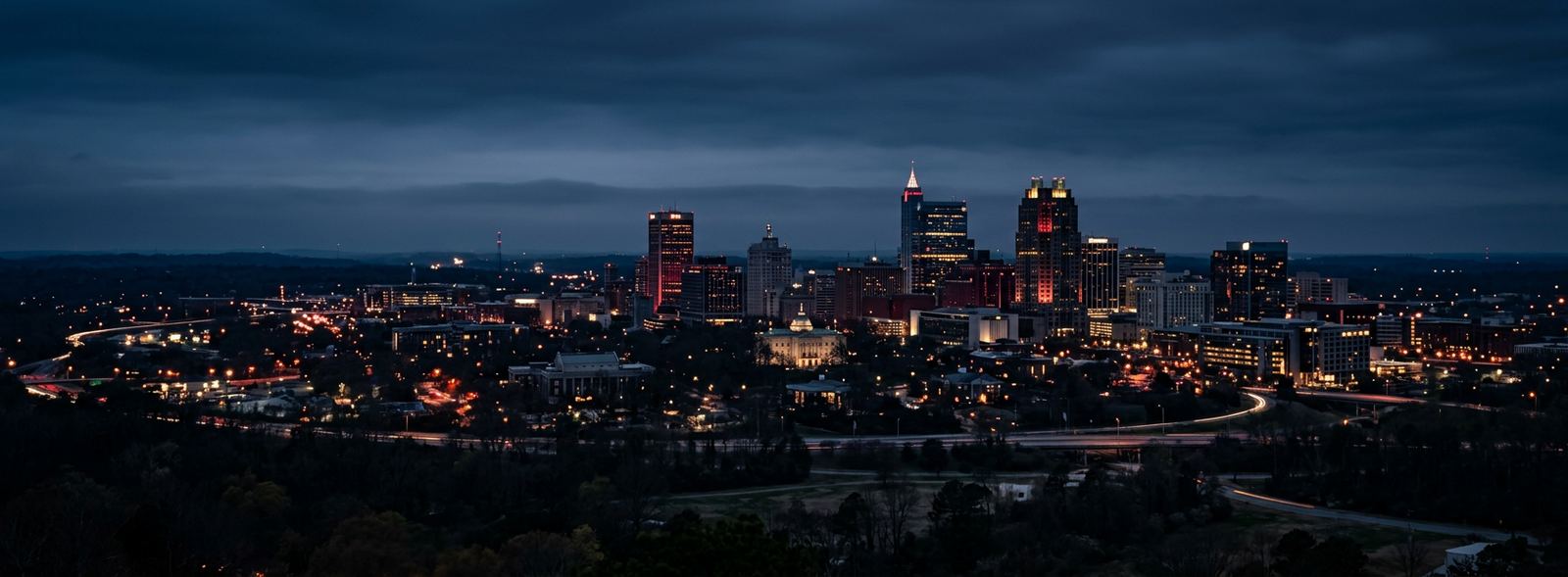 Aerial view of the Raleigh, North Carolina skyline at dusk, illustrating the metro area TactStack serves trade and service businesses in