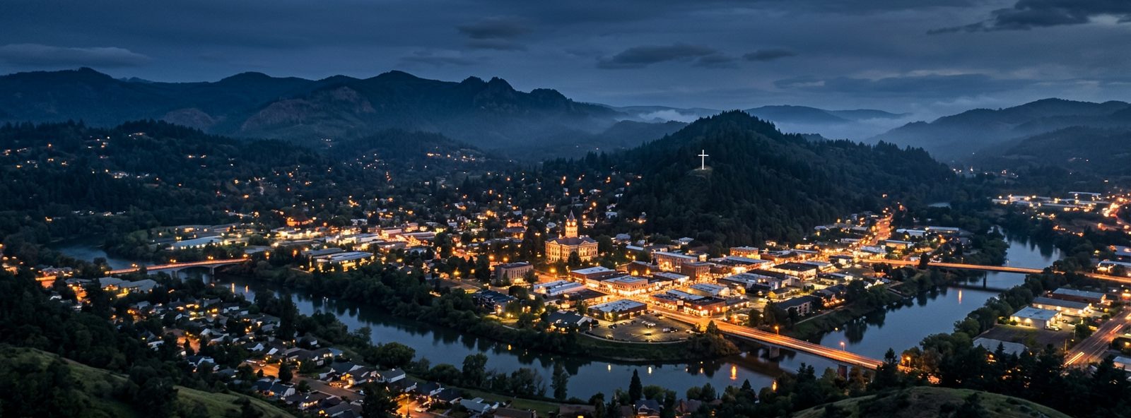 Aerial view of the Roseburg, Oregon skyline at dusk, illustrating the metro area TactStack serves trade and service businesses in